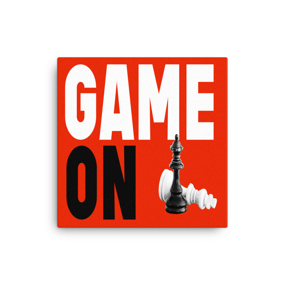 Block letters of Game On on red background with king and queen game pieces on canvas. 
